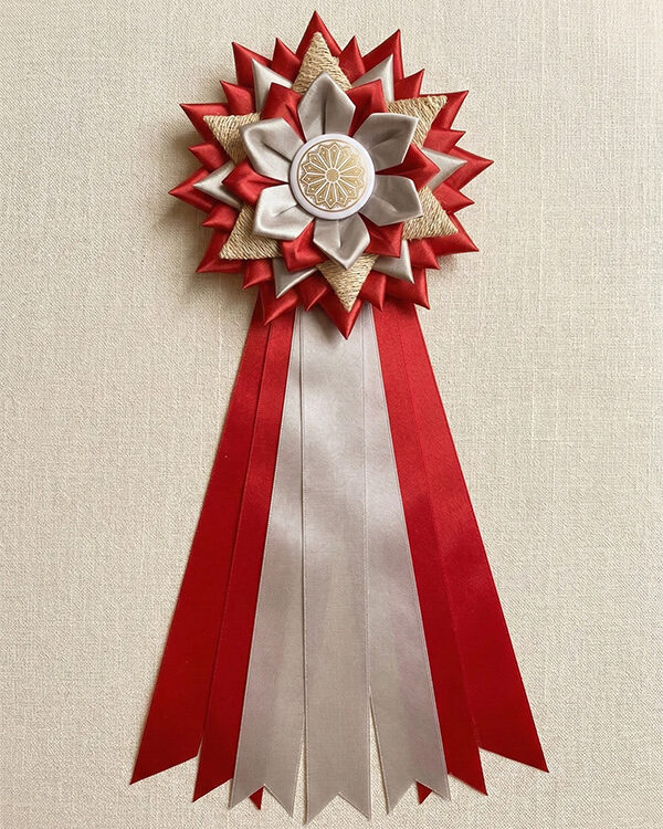 Award ribbon rosette with red and white satin petals, burlap accent, and custom button pin