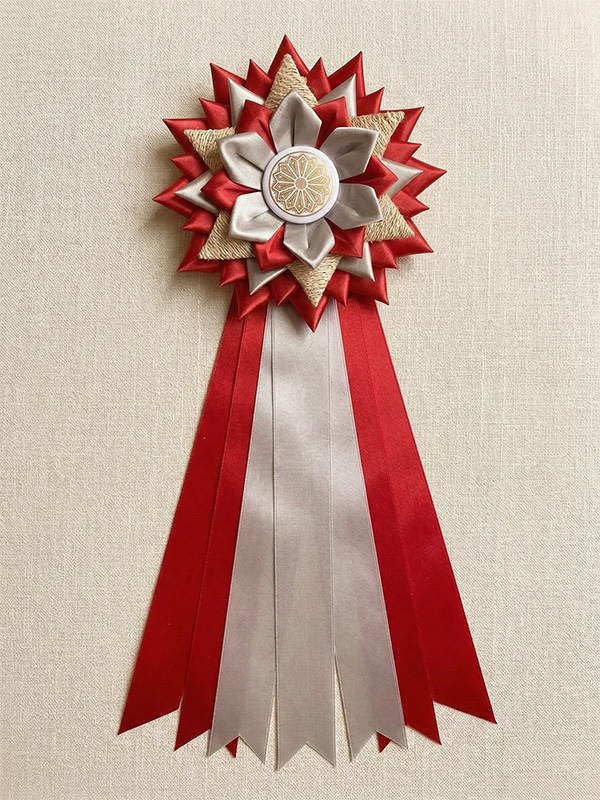 Award ribbon rosette with red and white satin petals, burlap accent, and custom button pin