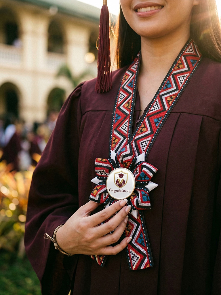 Graduate in maroon toga holding a handcrafted Rosette Lei with colorful woven ribbon and Congratulations centerpiece
