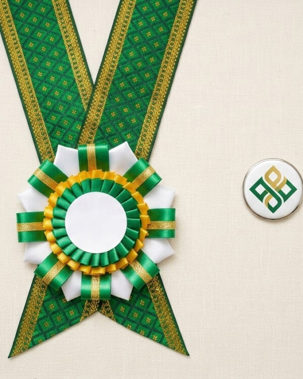 Rosette Lei flat-lay showing handcrafted rosette centerpiece with ribbon tails, woven Jacquard necklace, and custom button pin